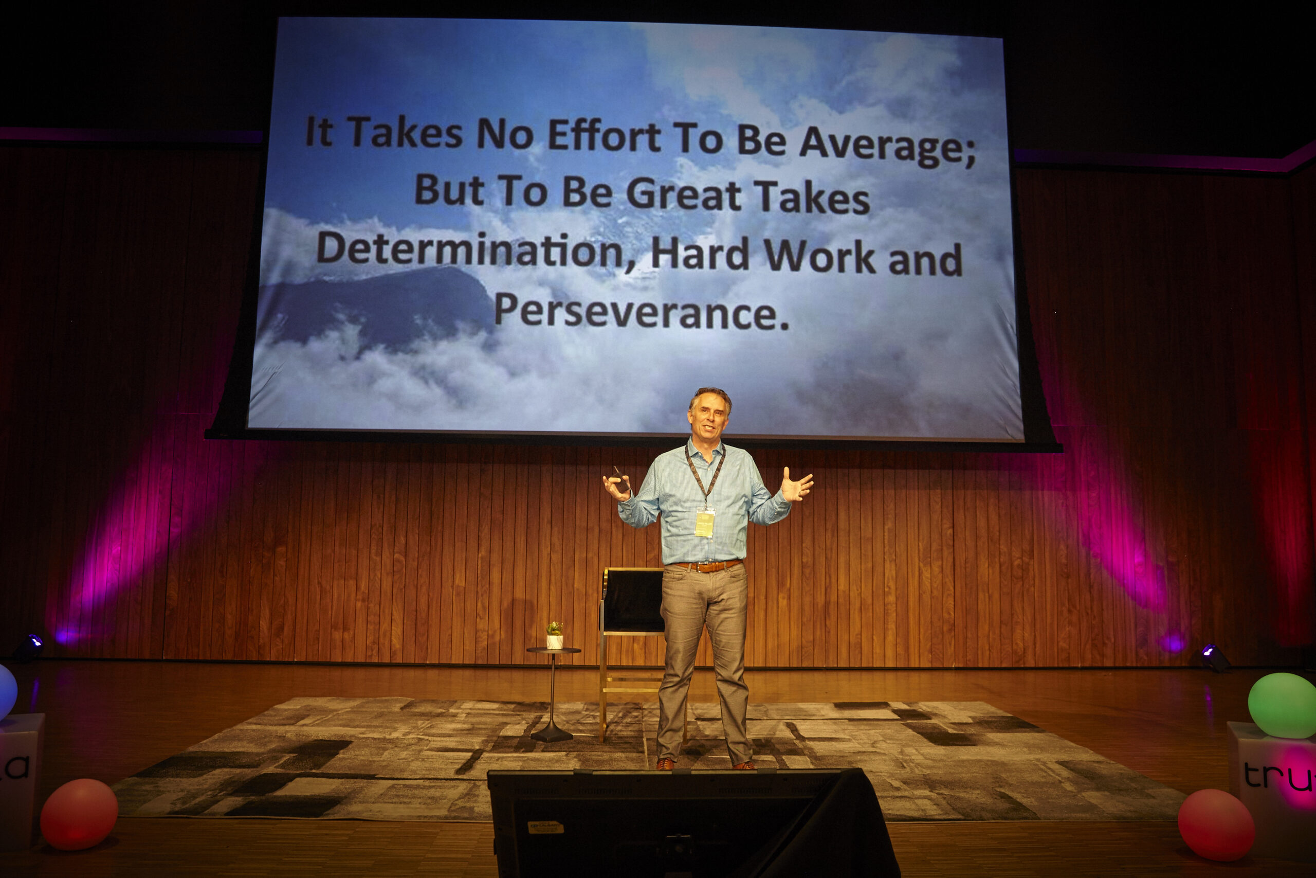 Lance Miller speaking at in front of a powerpoint presentation